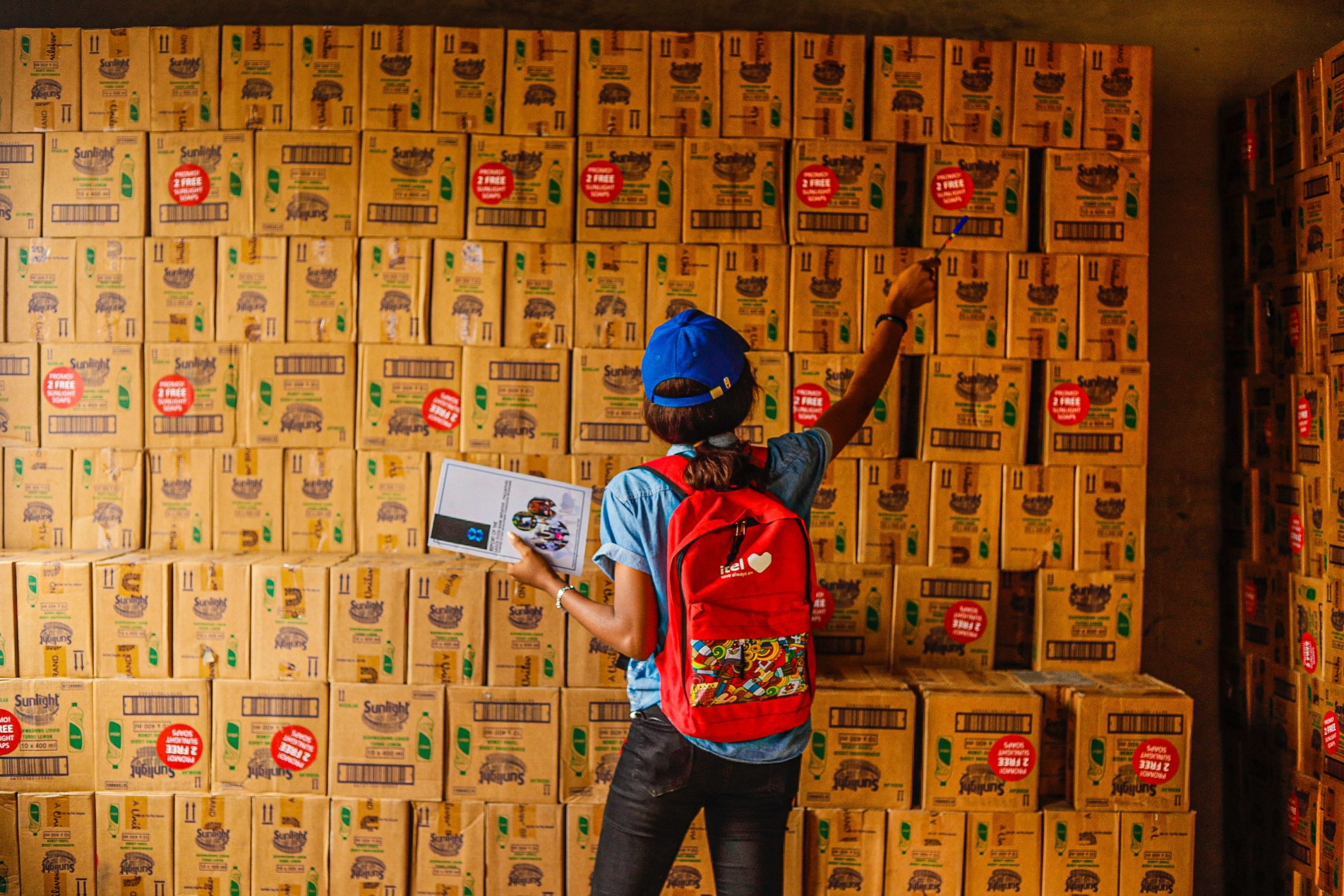 A worker pointing at distribution boxes at a warehouse