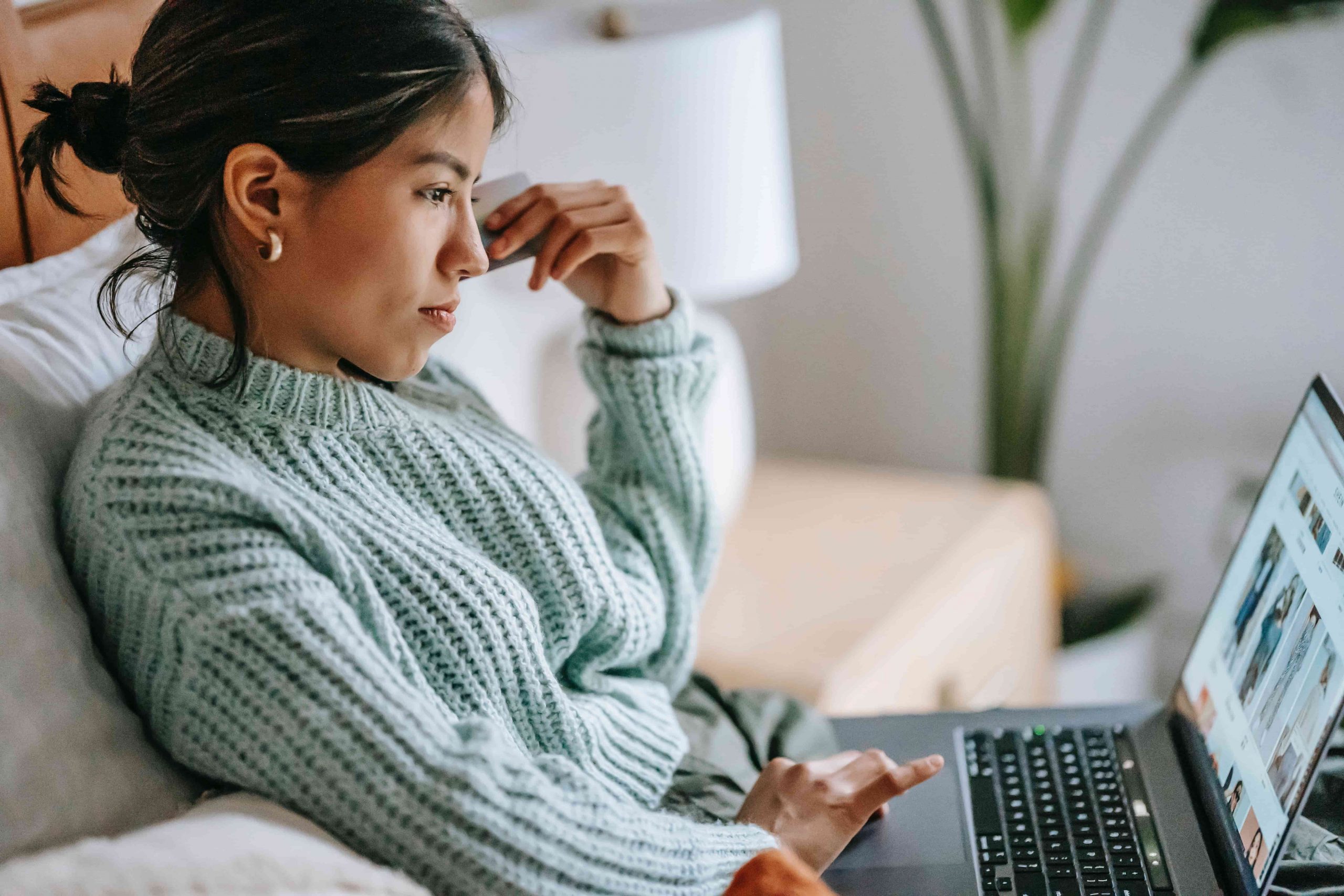 Young lady shopping online and paying via a credit card